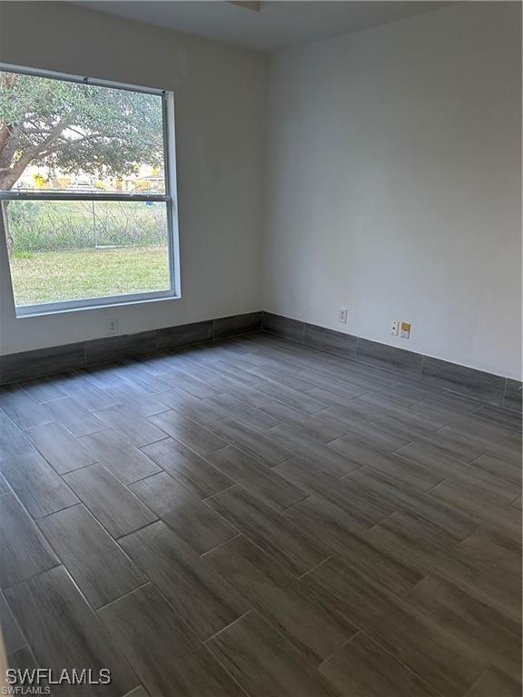 4520 19th St SW, Lehigh Acres, FL 33973 - unfurnished room featuring wood tiled floors