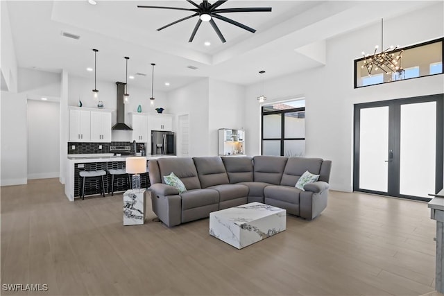 301 NW 36th Ave, Cape Coral, FL 33993 - living area with recessed lighting, a high ceiling, a tray ceiling, light wood-style flooring, and ceiling fan