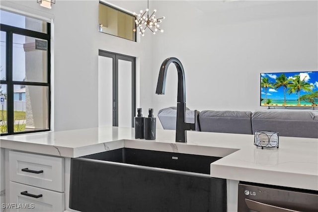 301 NW 36th Ave, Cape Coral, FL 33993 - kitchen with open floor plan, light countertops, a chandelier, and dishwasher