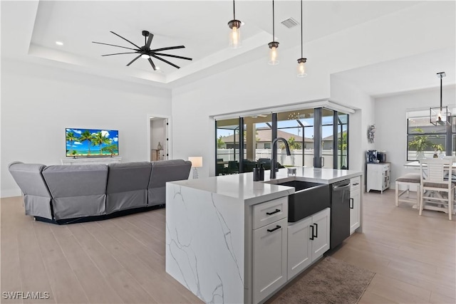 301 NW 36th Ave, Cape Coral, FL 33993 - kitchen featuring stainless steel dishwasher, a ceiling fan, light wood finished floors, light stone countertops, and decorative light fixtures