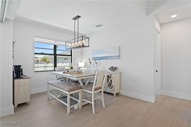 301 NW 36th Ave, Cape Coral, FL 33993 - dining room with light wood-type flooring and a chandelier