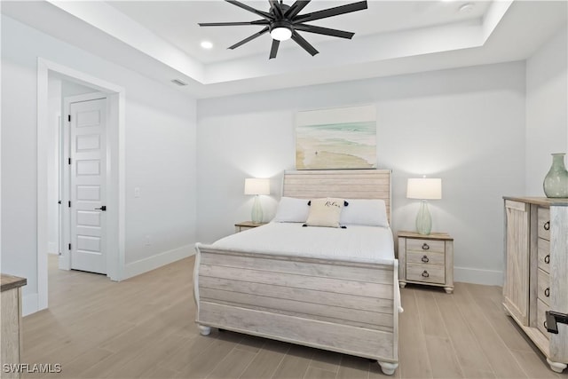 301 NW 36th Ave, Cape Coral, FL 33993 - bedroom featuring a tray ceiling, light wood finished floors, recessed lighting, and a ceiling fan