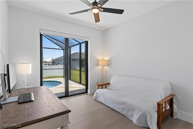 301 NW 36th Ave, Cape Coral, FL 33993 - bedroom featuring access to outside, a ceiling fan, and wood finished floors