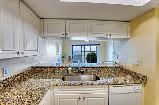 1900 Virginia Ave Unit 102, Fort Myers, FL 33901 - kitchen featuring dishwasher, white cabinets, dark stone counters, and a peninsula