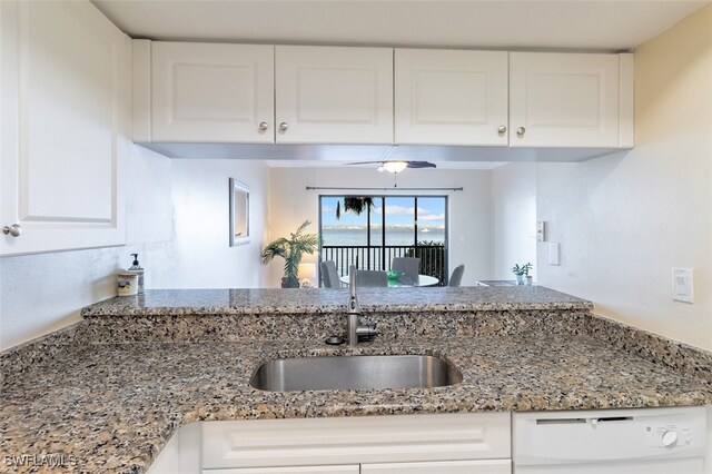 1900 Virginia Ave Unit 102, Fort Myers, FL 33901 - kitchen with white dishwasher, light stone counters, and white cabinetry