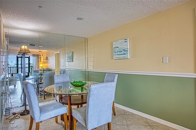 1900 Virginia Ave Unit 102, Fort Myers, FL 33901 - tiled dining room featuring baseboards and a textured ceiling
