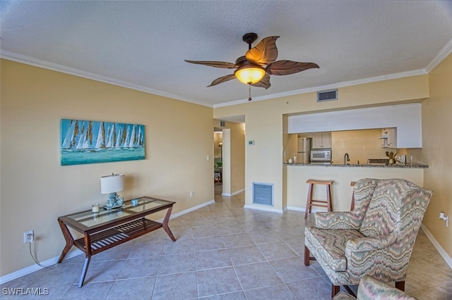 1900 Virginia Ave Unit 102, Fort Myers, FL 33901 - sitting room with crown molding, a ceiling fan, tile patterned flooring, and a textured ceiling