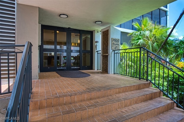 1900 Virginia Ave Unit 102, Fort Myers, FL 33901 - property entrance with french doors, a balcony, and stucco siding