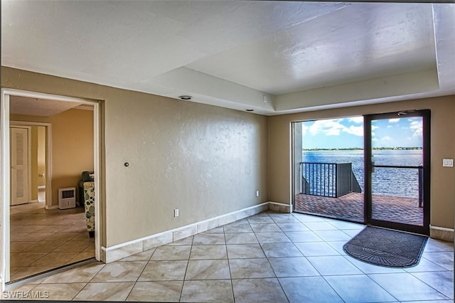 1900 Virginia Ave Unit 102, Fort Myers, FL 33901 - unfurnished room featuring a raised ceiling, light tile patterned floors, and a water view