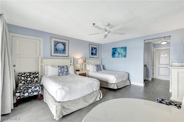 900 Broad Ave S Unit 320, Naples, FL 34102 - bedroom featuring a textured ceiling, a ceiling fan, and tile patterned flooring
