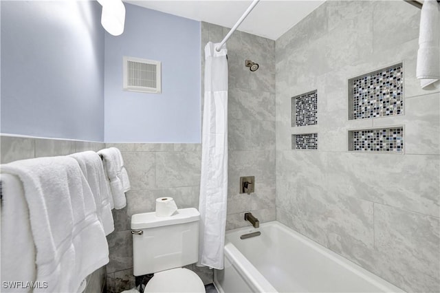 900 Broad Ave S Unit 320, Naples, FL 34102 - bathroom featuring shower / bathtub combination with curtain, tile walls, and wainscoting
