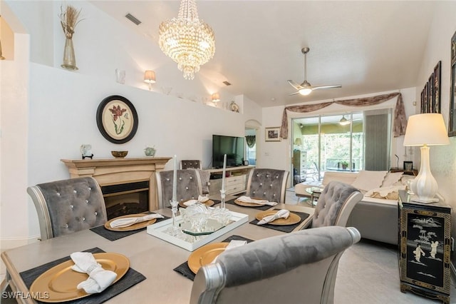 15029 Toscana Way, Naples, FL 34120 - tiled dining area with vaulted ceiling, ceiling fan, and a chandelier