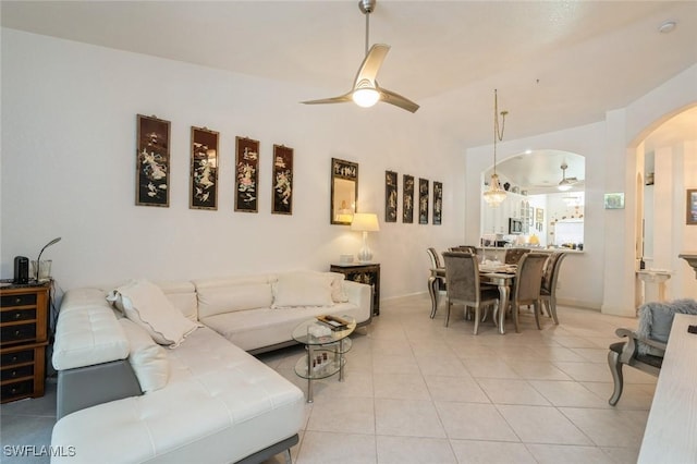 15029 Toscana Way, Naples, FL 34120 - living room with ceiling fan, arched walkways, and light tile patterned floors