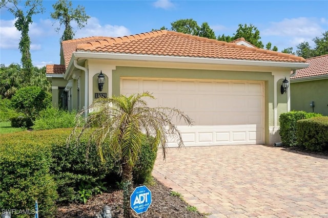 15029 Toscana Way, Naples, FL 34120 - mediterranean / spanish house featuring driveway, a tile roof, stucco siding, and a garage