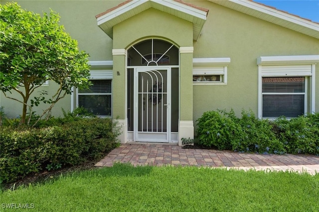 15029 Toscana Way, Naples, FL 34120 - doorway to property with stucco siding