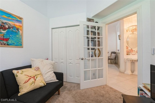 15029 Toscana Way, Naples, FL 34120 - living area featuring carpet, french doors, and tile patterned floors