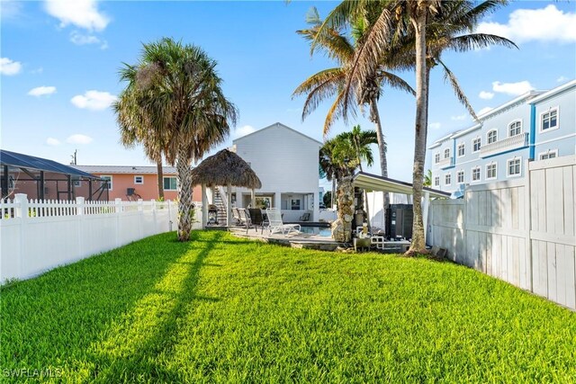 111 Bahia Via, Fort Myers Beach, FL 33931 - rear view of house with a fenced backyard and a gazebo