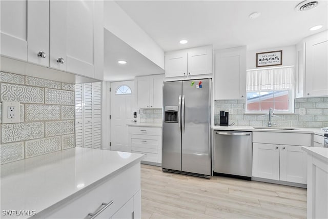 111 Bahia Via, Fort Myers Beach, FL 33931 - kitchen featuring stainless steel appliances, light countertops, plenty of natural light, white cabinets, and recessed lighting