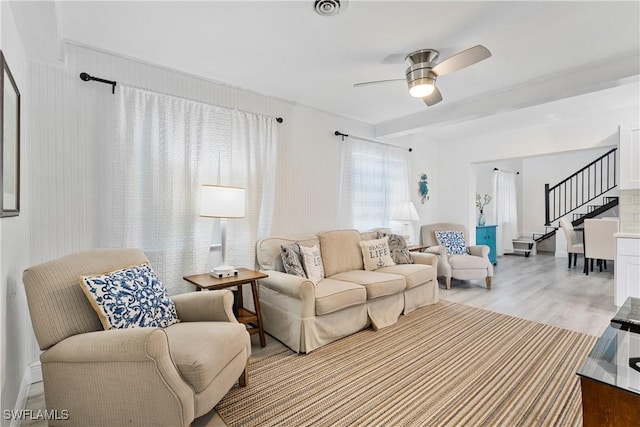 111 Bahia Via, Fort Myers Beach, FL 33931 - living room with stairway, light wood-style flooring, and ceiling fan