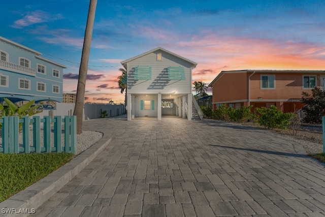 111 Bahia Via, Fort Myers Beach, FL 33931 - coastal home with a carport, stairs, and decorative driveway