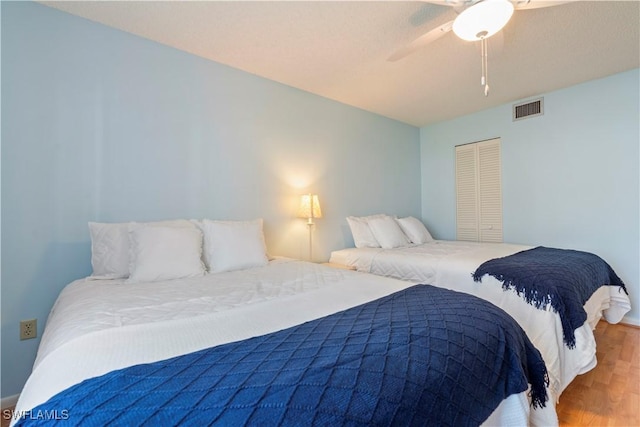 3200 Binnacle Dr Unit C1, Naples, FL 34103 - bedroom with wood finished floors, a closet, and ceiling fan