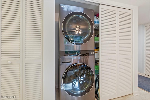 3200 Binnacle Dr Unit C1, Naples, FL 34103 - laundry room with stacked washer and clothes dryer and baseboards