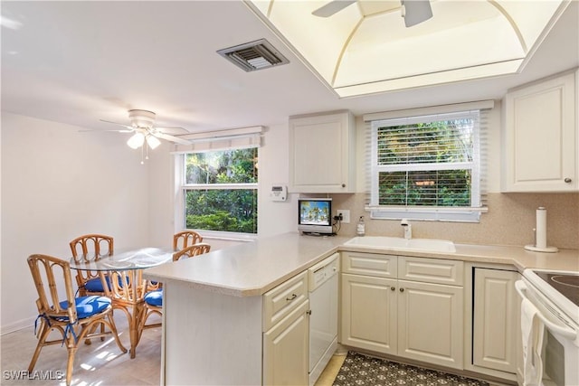 3200 Binnacle Dr Unit C1, Naples, FL 34103 - kitchen with ceiling fan, white appliances, a peninsula, and light countertops