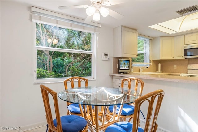 3200 Binnacle Dr Unit C1, Naples, FL 34103 - dining space with plenty of natural light and ceiling fan