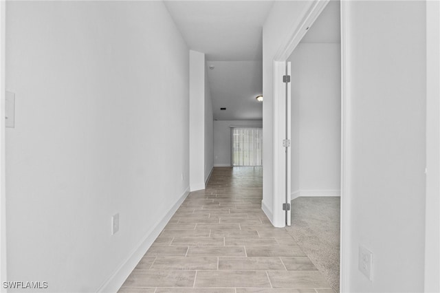 2801 50th St SW, Lehigh Acres, FL 33976 - hallway with light wood-style flooring and baseboards