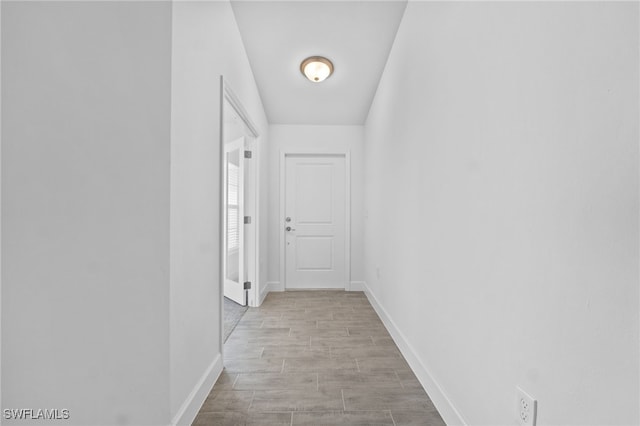 2801 50th St SW, Lehigh Acres, FL 33976 - corridor with baseboards and light wood finished floors
