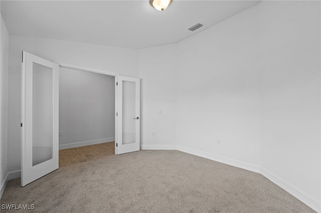 2801 50th St SW, Lehigh Acres, FL 33976 - unfurnished bedroom featuring carpet floors and french doors