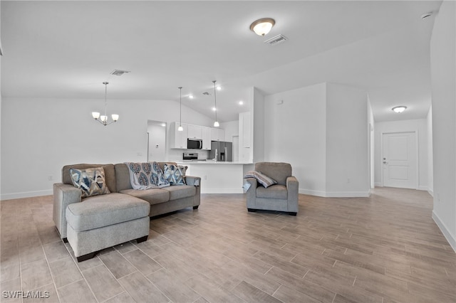 2801 50th St SW, Lehigh Acres, FL 33976 - living room with light wood-style floors, a chandelier, and vaulted ceiling