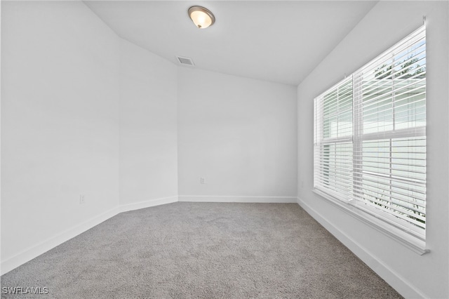 2801 50th St SW, Lehigh Acres, FL 33976 - carpeted spare room with baseboards and vaulted ceiling