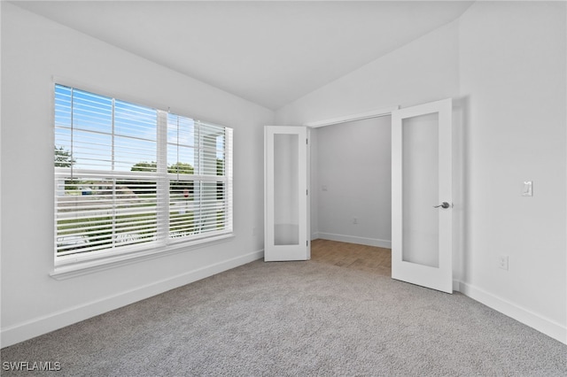 2801 50th St SW, Lehigh Acres, FL 33976 - unfurnished bedroom with carpet, lofted ceiling, and french doors