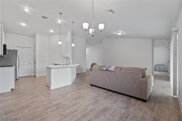 2801 50th St SW, Lehigh Acres, FL 33976 - living area featuring lofted ceiling, light wood-style flooring, a chandelier, and recessed lighting