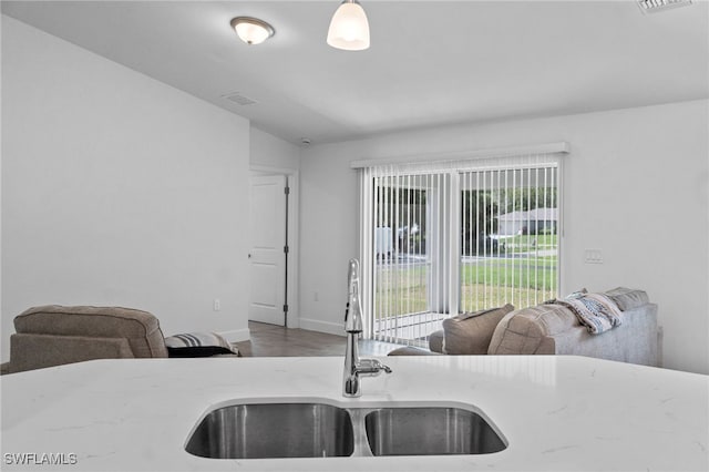 2801 50th St SW, Lehigh Acres, FL 33976 - kitchen with wood finished floors, open floor plan, and light stone counters
