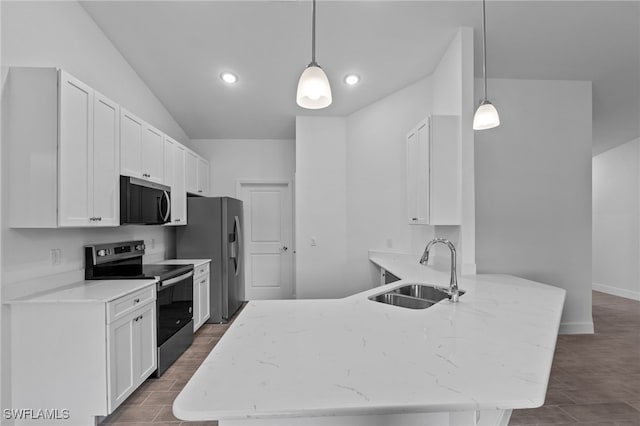 2801 50th St SW, Lehigh Acres, FL 33976 - kitchen with appliances with stainless steel finishes, a peninsula, white cabinets, dark wood finished floors, and light stone countertops