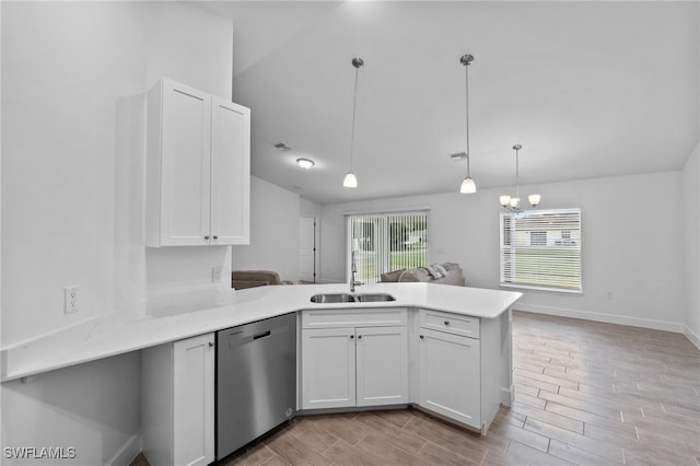 2801 50th St SW, Lehigh Acres, FL 33976 - kitchen with dishwasher, a peninsula, white cabinetry, lofted ceiling, and light wood-type flooring