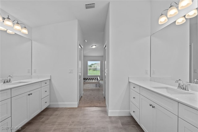 2801 50th St SW, Lehigh Acres, FL 33976 - ensuite bathroom featuring two vanities and baseboards