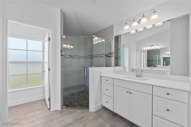 2801 50th St SW, Lehigh Acres, FL 33976 - full bath featuring lofted ceiling, a shower stall, vanity, and wood finished floors
