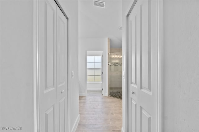2801 50th St SW, Lehigh Acres, FL 33976 - corridor with light wood-style flooring and baseboards