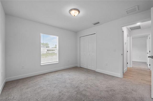 2801 50th St SW, Lehigh Acres, FL 33976 - unfurnished bedroom featuring carpet floors, attic access, and a closet