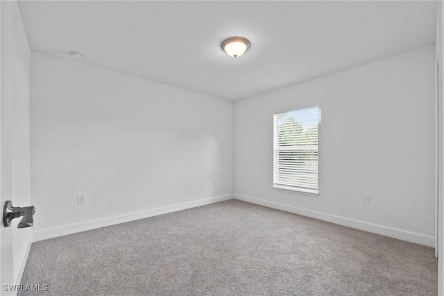 2801 50th St SW, Lehigh Acres, FL 33976 - carpeted spare room featuring baseboards and a smoke detector