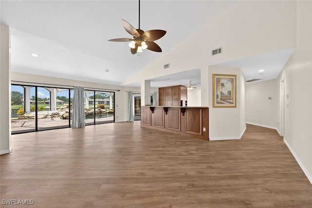 8060 Glenfinnan Cir, Fort Myers, FL 33912 - unfurnished living room featuring ceiling fan, wood finished floors, high vaulted ceiling, and recessed lighting
