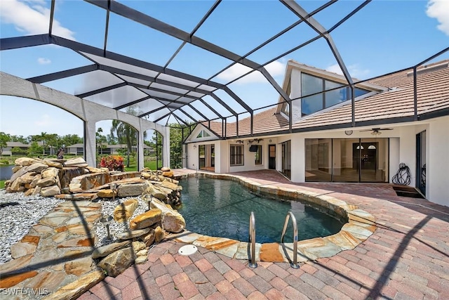 8060 Glenfinnan Cir, Fort Myers, FL 33912 - outdoor pool featuring a ceiling fan, a patio, and glass enclosure