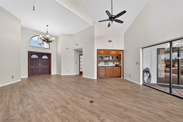 8060 Glenfinnan Cir, Fort Myers, FL 33912 - unfurnished living room with ceiling fan, high vaulted ceiling, light wood-style flooring, and a chandelier
