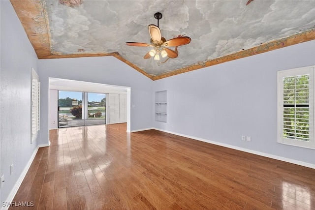 8060 Glenfinnan Cir, Fort Myers, FL 33912 - unfurnished room with built in features, vaulted ceiling, wood finished floors, and ceiling fan