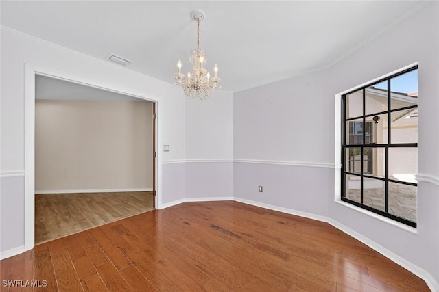 8060 Glenfinnan Cir, Fort Myers, FL 33912 - spare room with a chandelier, wood finished floors, and ornamental molding