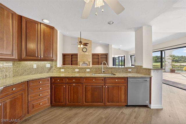 8060 Glenfinnan Cir, Fort Myers, FL 33912 - kitchen featuring a ceiling fan, light wood-style floors, lofted ceiling, light stone countertops, and backsplash