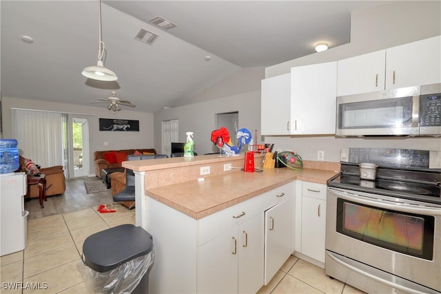 936-938 Eisenhower Blvd, Lehigh Acres, FL 33974 - kitchen with stainless steel appliances, light tile patterned floors, a peninsula, vaulted ceiling, and open floor plan